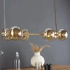 Pendelleuchte PLUTO 6-flammig Messing & Amberglas Kugeln, Breite 80cm